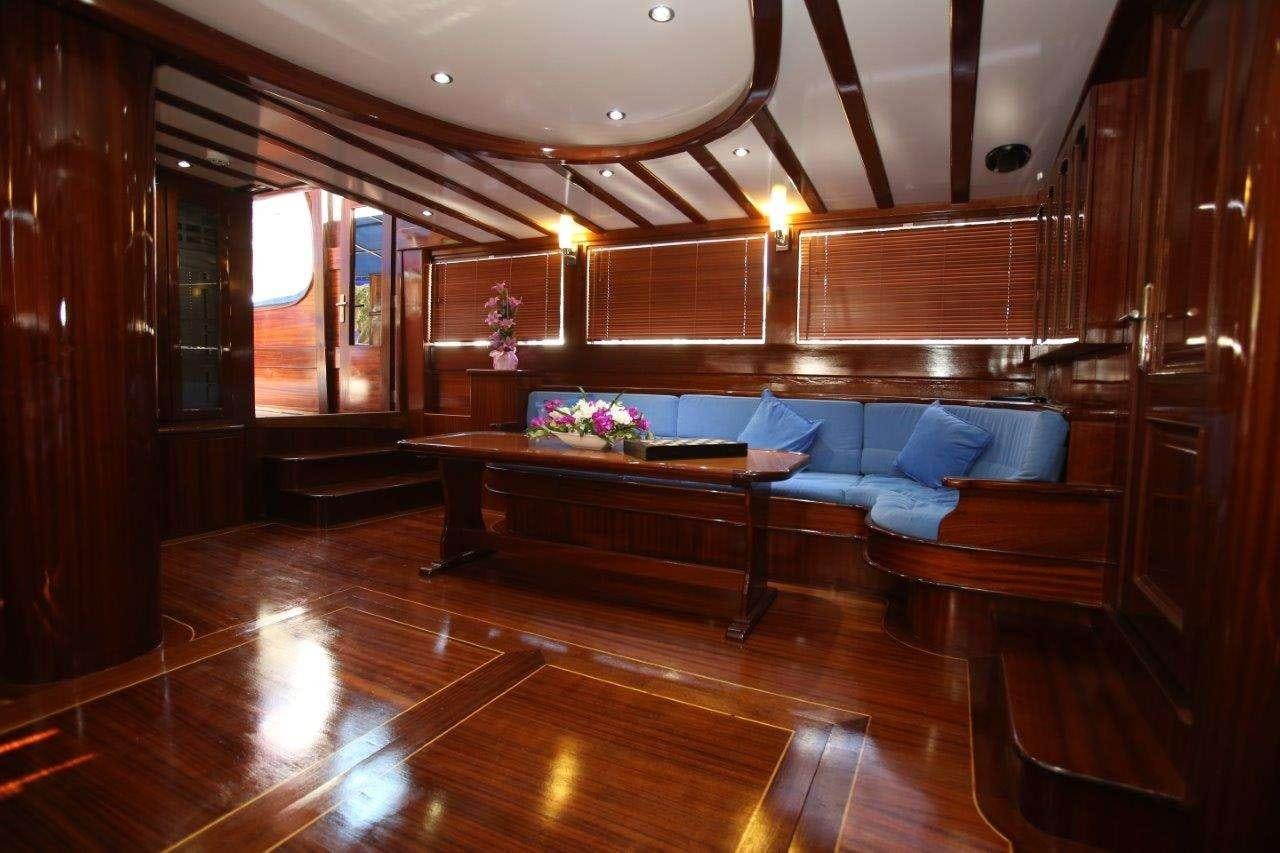 a room with a couch and a table aboard SEMERCIOGLU IV Yacht for Charter