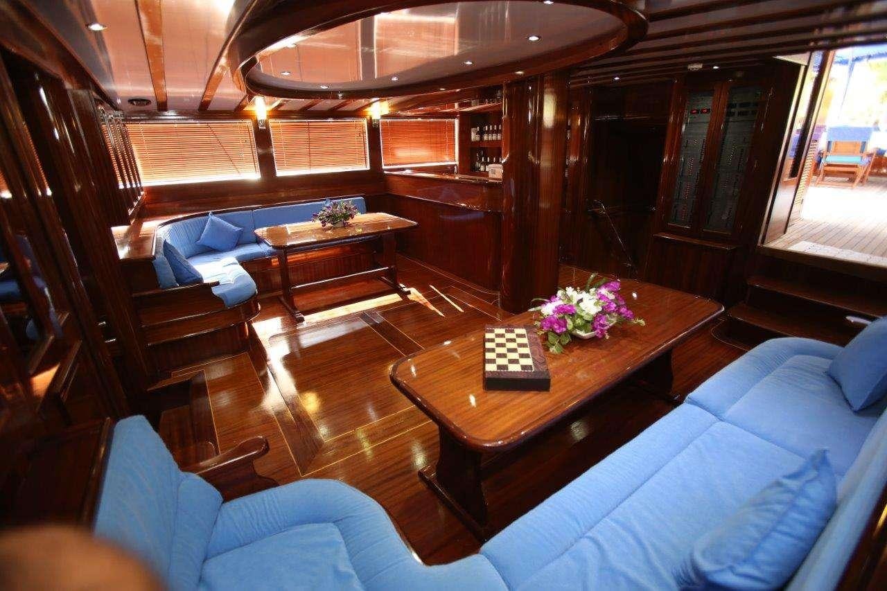 a living room with a wood table aboard SEMERCIOGLU IV Yacht for Charter