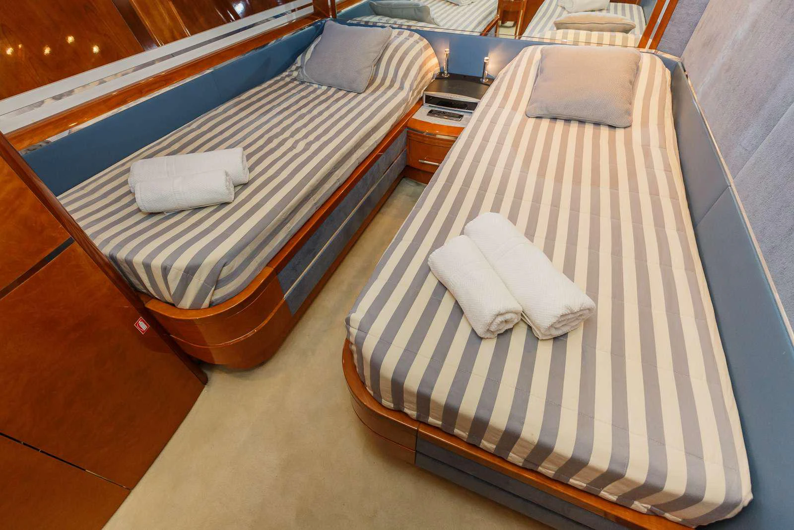a bed with white and black striped sheets aboard VELLMARI Yacht for Charter