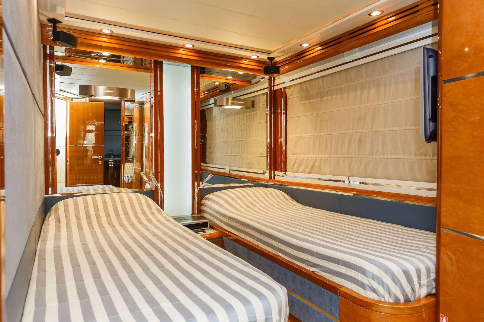 a room with beds and a window aboard VELLMARI Yacht for Charter