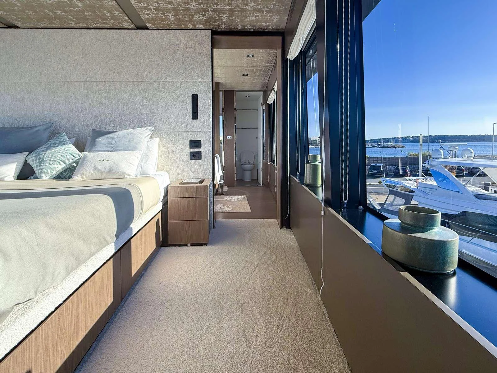 a room with a bed and a window aboard KOKONUT'S WALLY Yacht for Charter