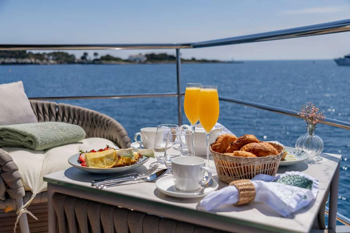 a table with food and drinks on it aboard KOKONUT'S WALLY Yacht for Charter