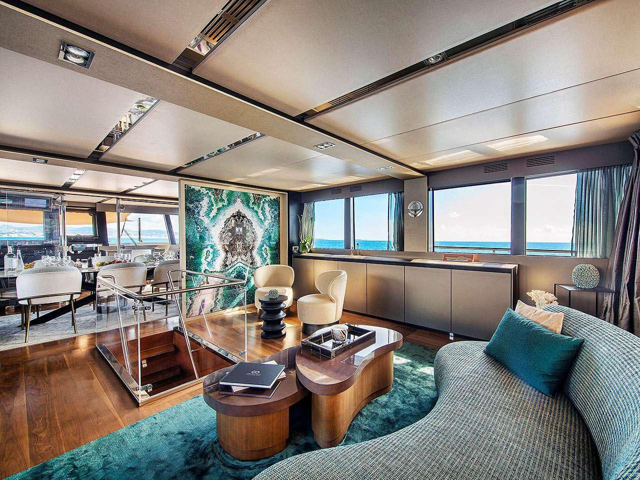 a living room with a large window aboard KOKONUT'S WALLY Yacht for Charter