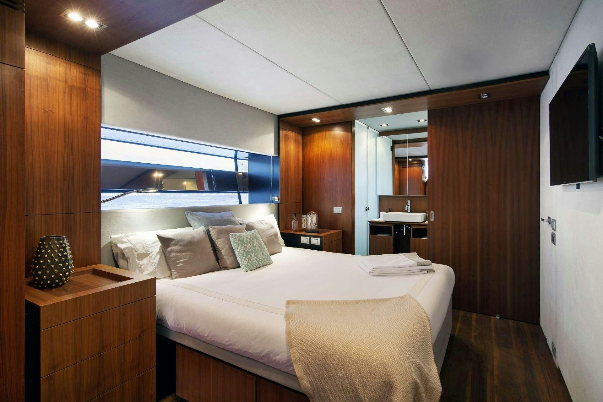 a room with a bed and a window aboard KOKONUT'S WALLY Yacht for Charter