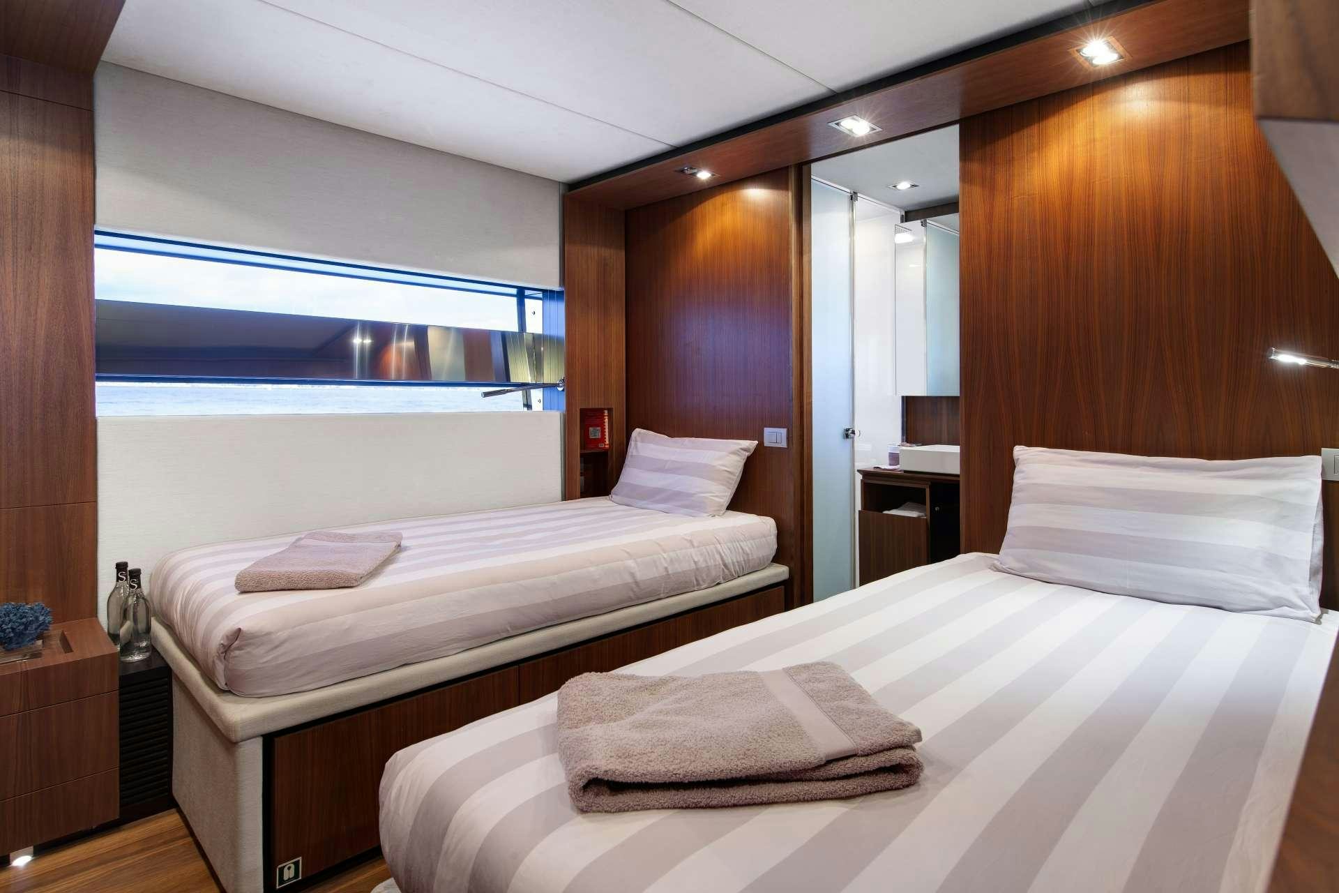 a room with two beds aboard KOKONUT'S WALLY Yacht for Charter