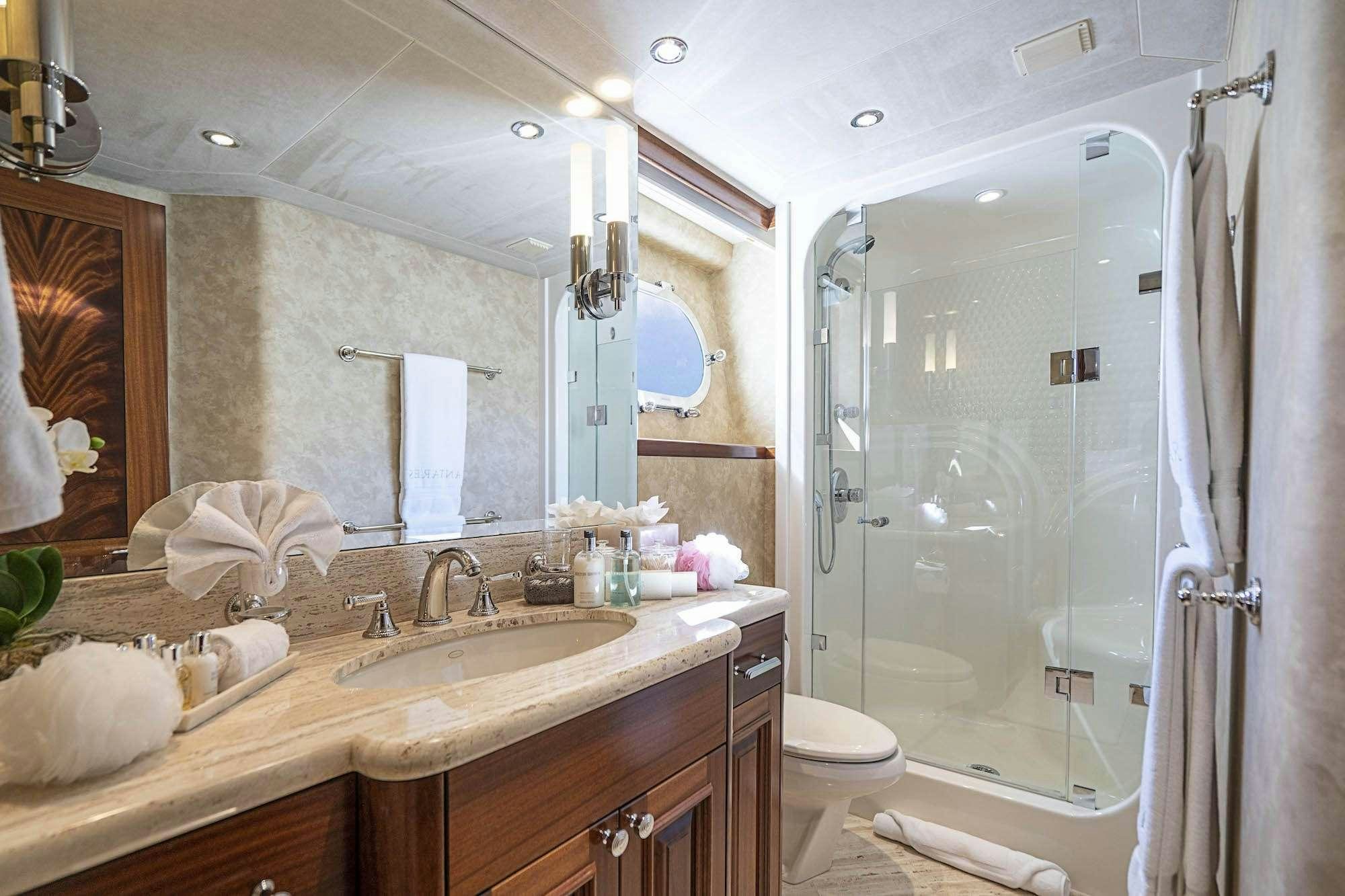 a bathroom with a glass shower door aboard ANTARES Yacht for Charter