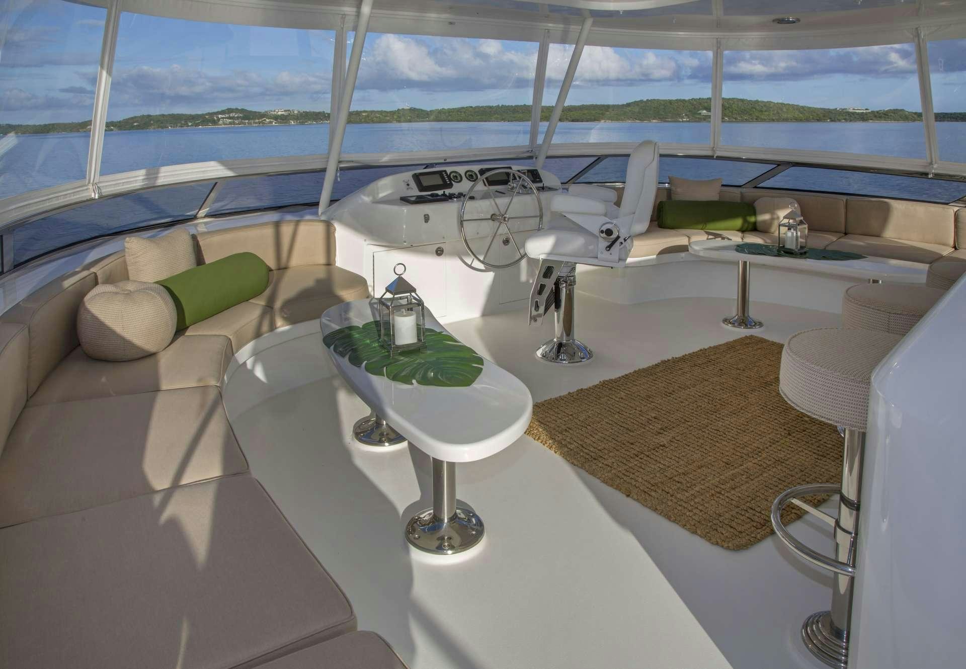 a room with a bed and a table with a fan aboard ANTARES Yacht for Charter