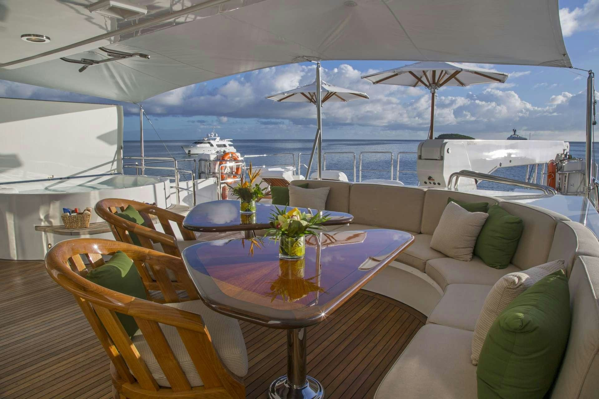 a table with chairs and umbrellas on it aboard ANTARES Yacht for Charter