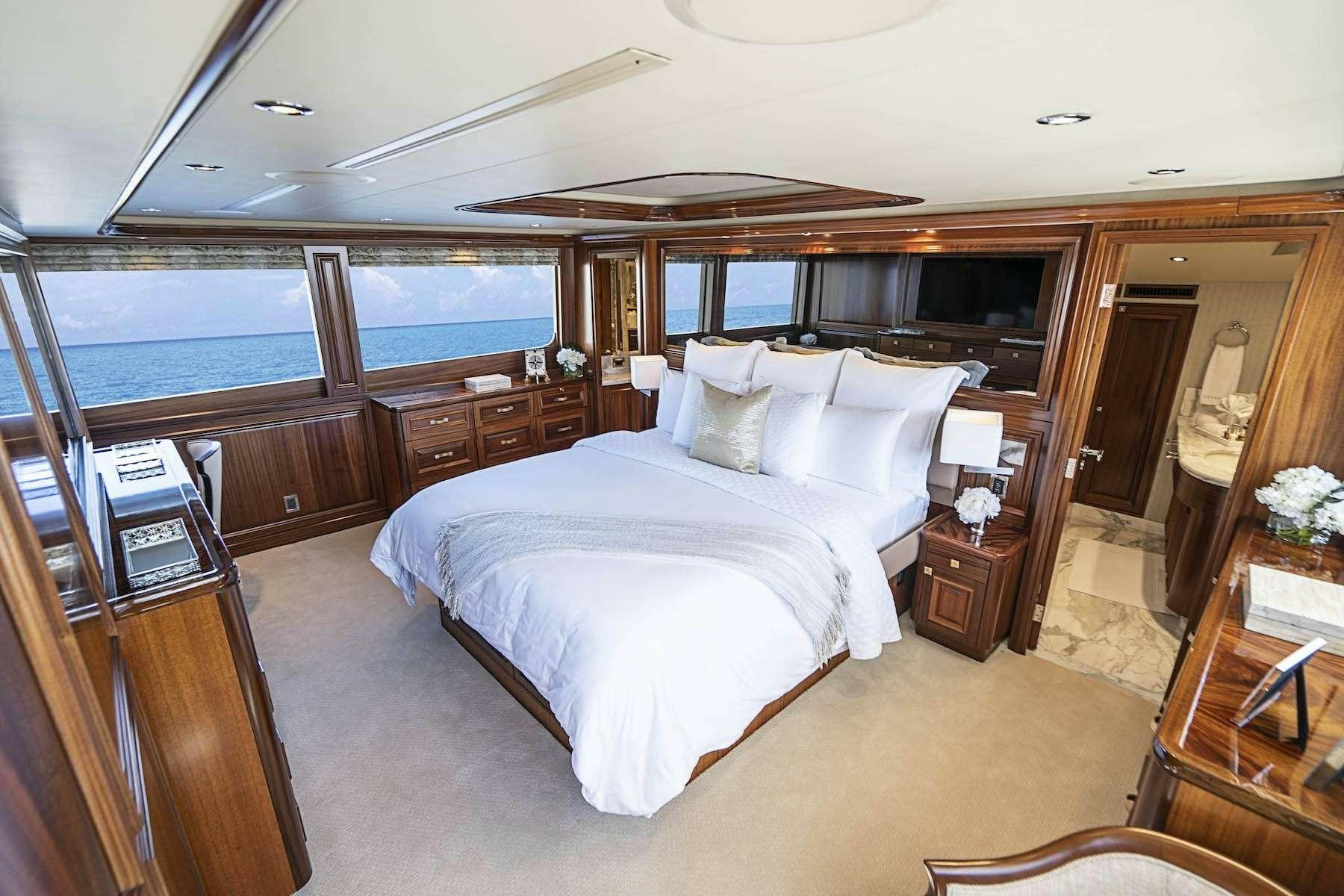 a bedroom with a large bed aboard ANTARES Yacht for Charter