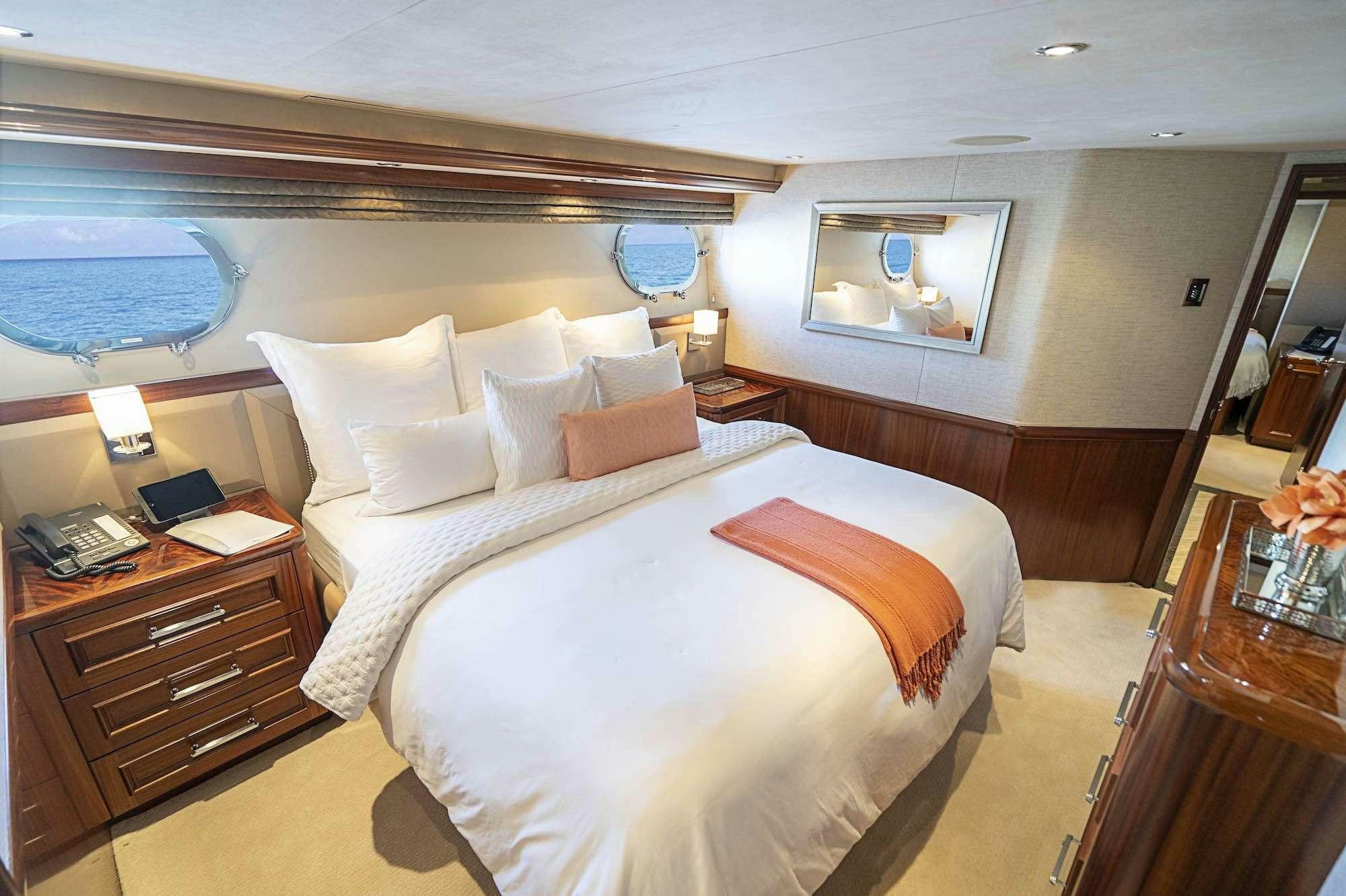 a hotel room with a bed and a desk aboard ANTARES Yacht for Charter