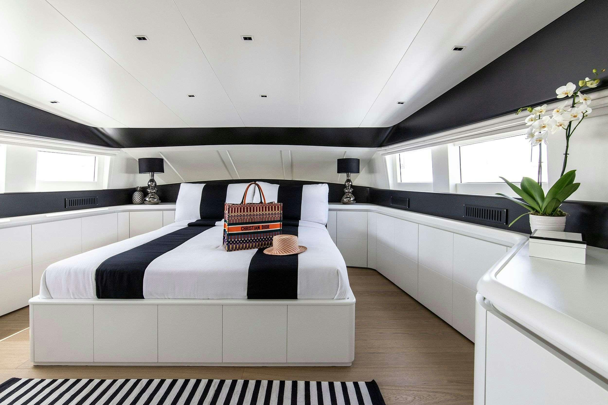 a room with a bed and a chair aboard PROJECT STEEL Yacht for Charter