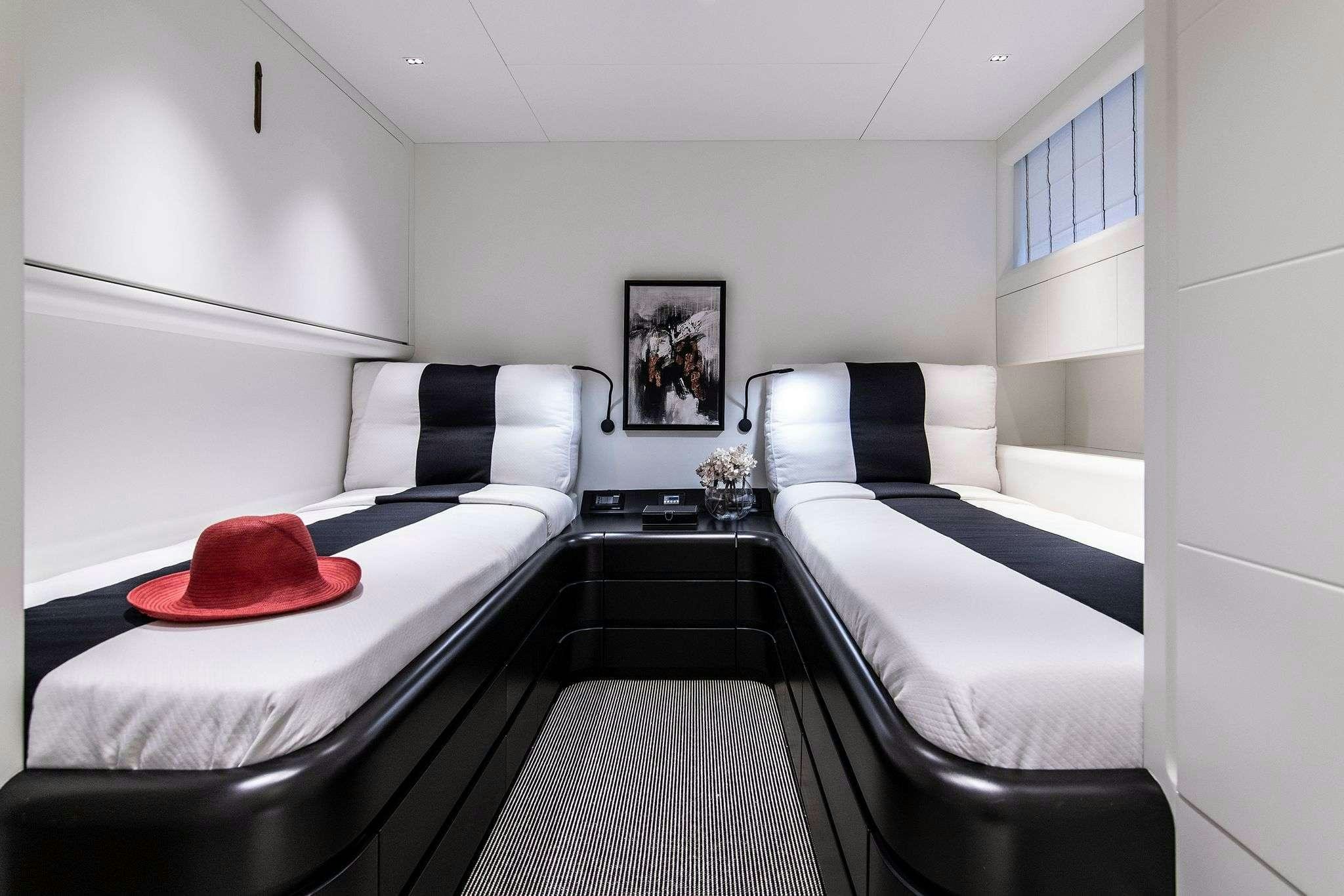 a room with two beds aboard PROJECT STEEL Yacht for Charter