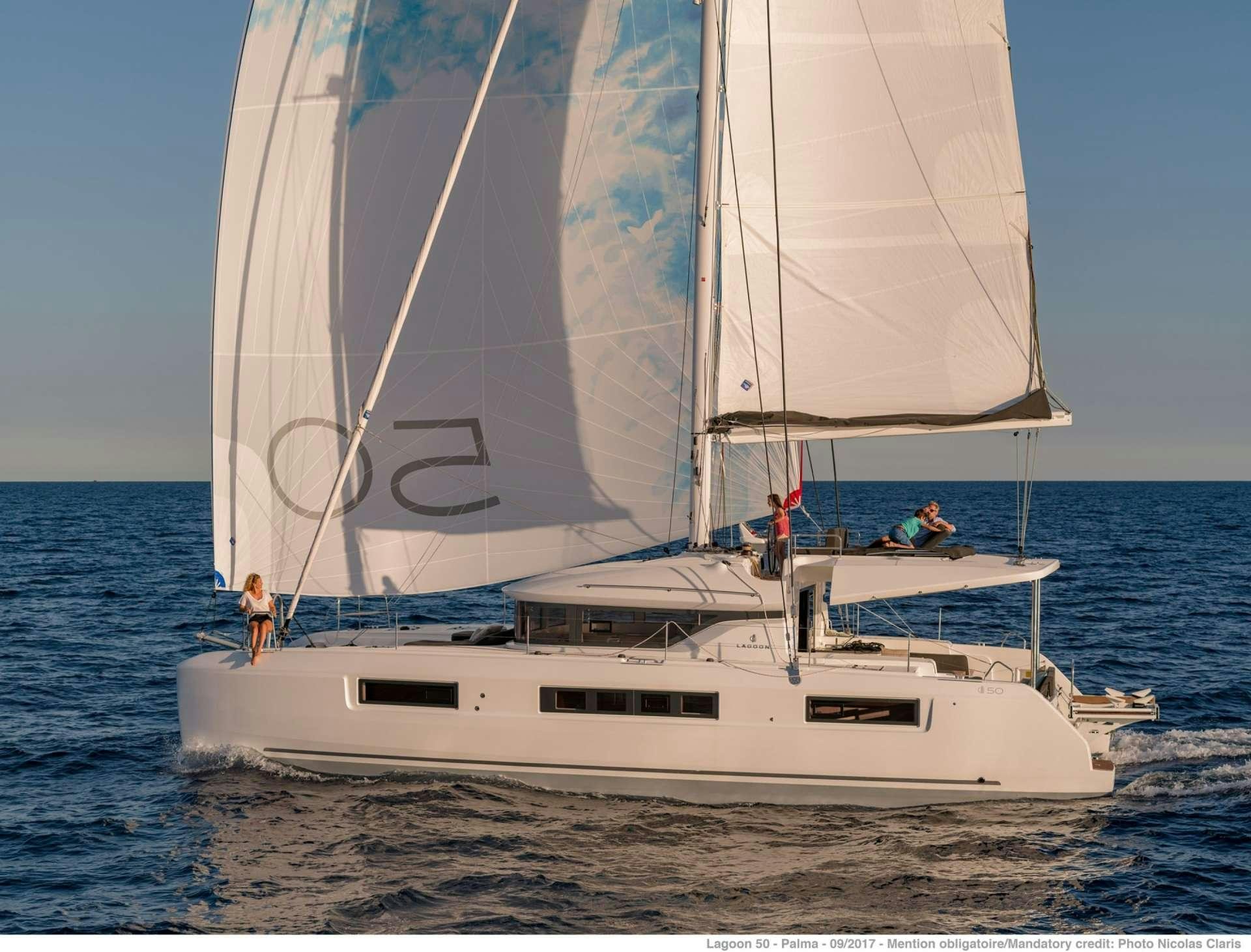 a white sailboat on the water aboard HAPPY FEET Yacht for Charter