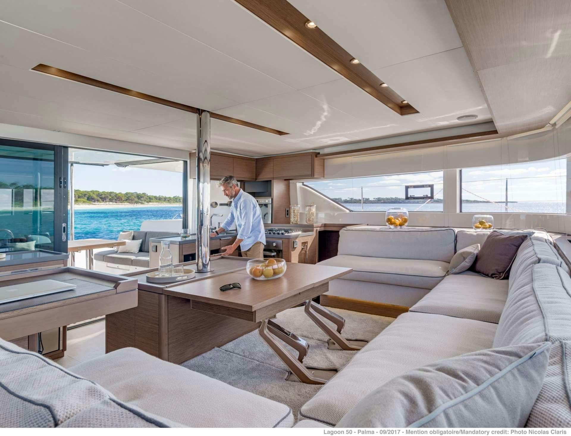 a person standing in a living room aboard HAPPY FEET Yacht for Charter