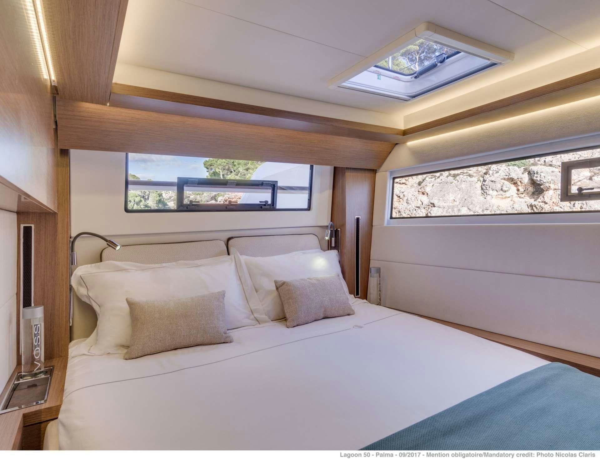 a bed with white sheets aboard HAPPY FEET Yacht for Charter