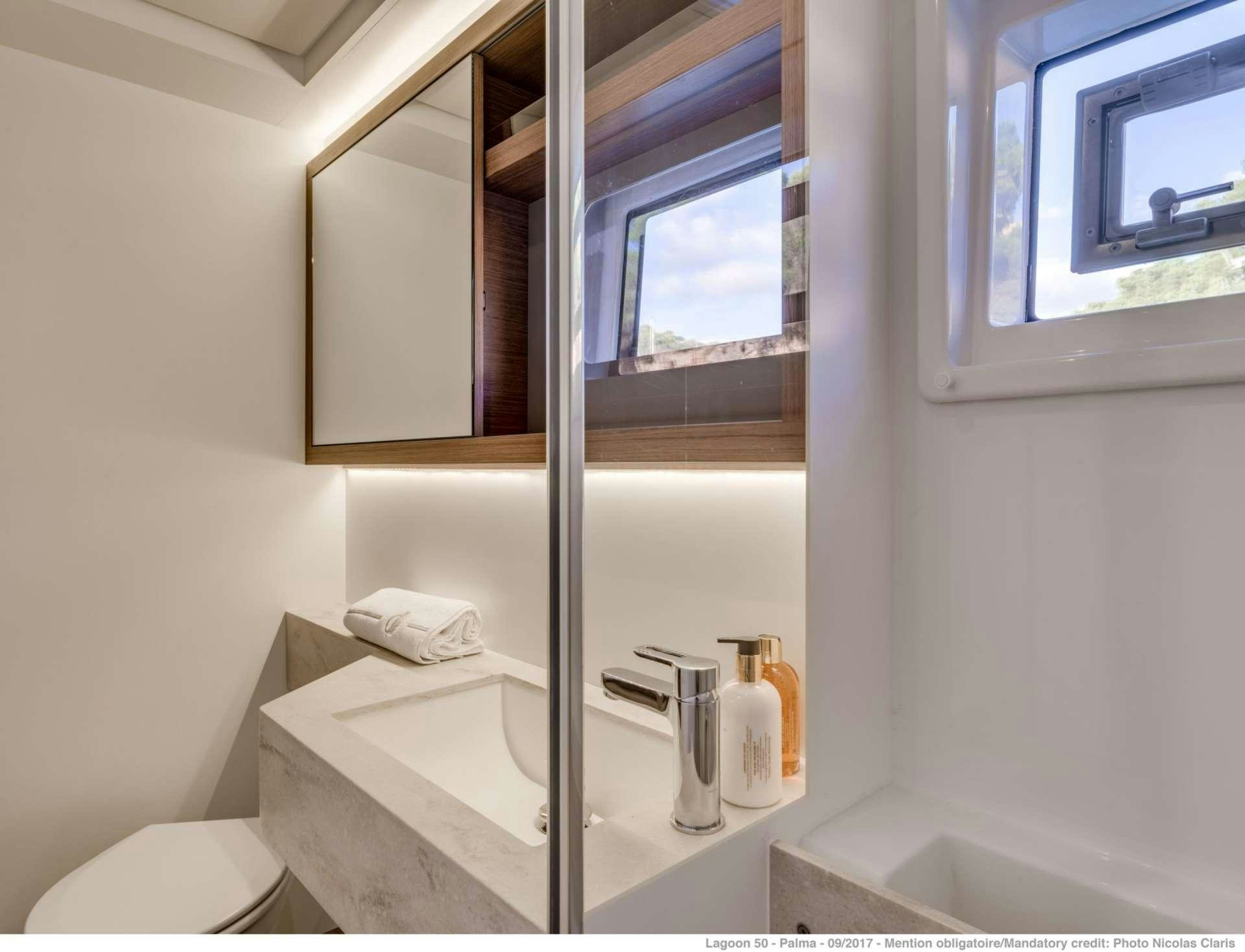 a bathroom with a standup shower aboard HAPPY FEET Yacht for Charter