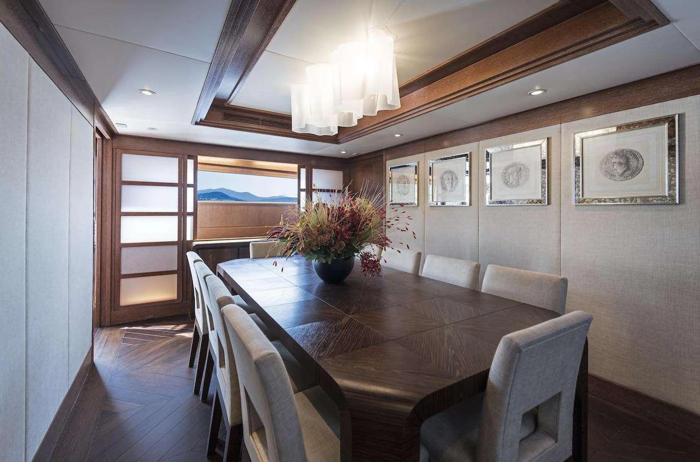 The yacht's dining area features a sophisticated table setting with elegant decor and ample seating. aboard KALIMERA Yacht for Charter