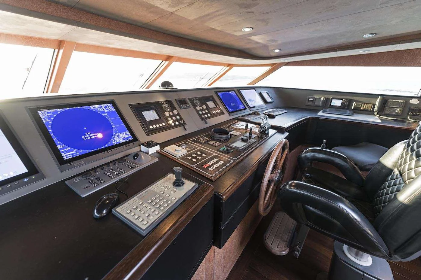 The helm station features advanced navigation equipment and luxurious seating. aboard KALIMERA Yacht for Charter