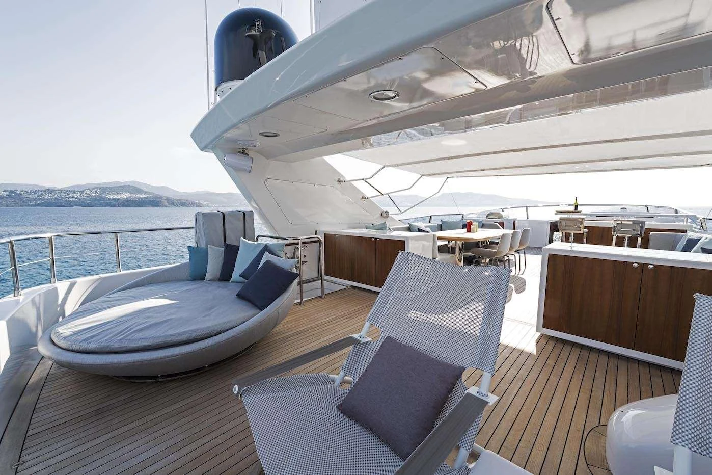 The aft deck offers a spacious and luxurious outdoor lounging area with comfortable seating and stunning views. aboard KALIMERA Yacht for Charter