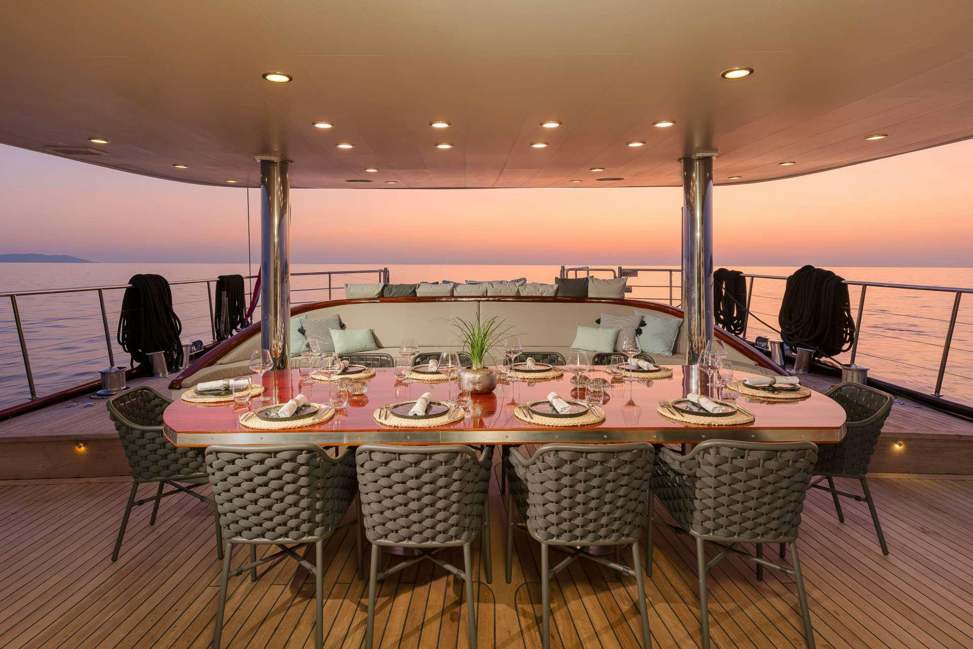 a table set for a dinner party aboard LADY GITA Yacht for Charter