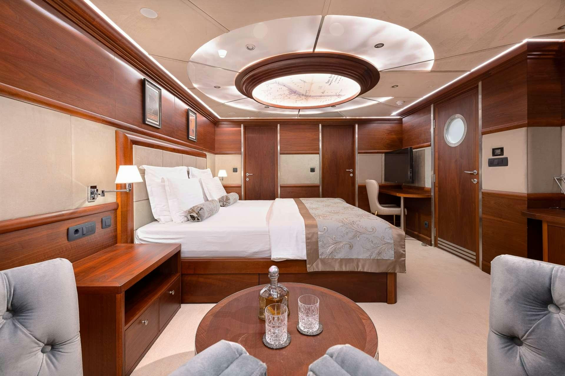 a room with a bed and a table aboard LADY GITA Yacht for Charter