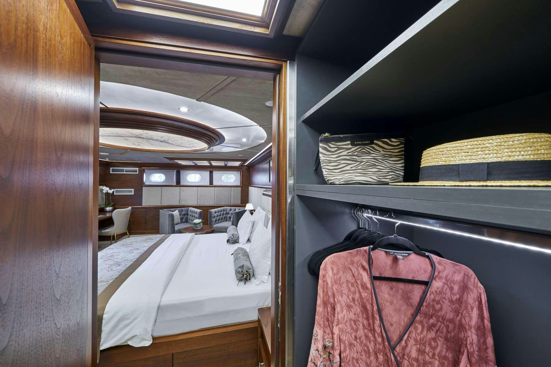 a room with a bed and a couple of cats in it aboard LADY GITA Yacht for Charter