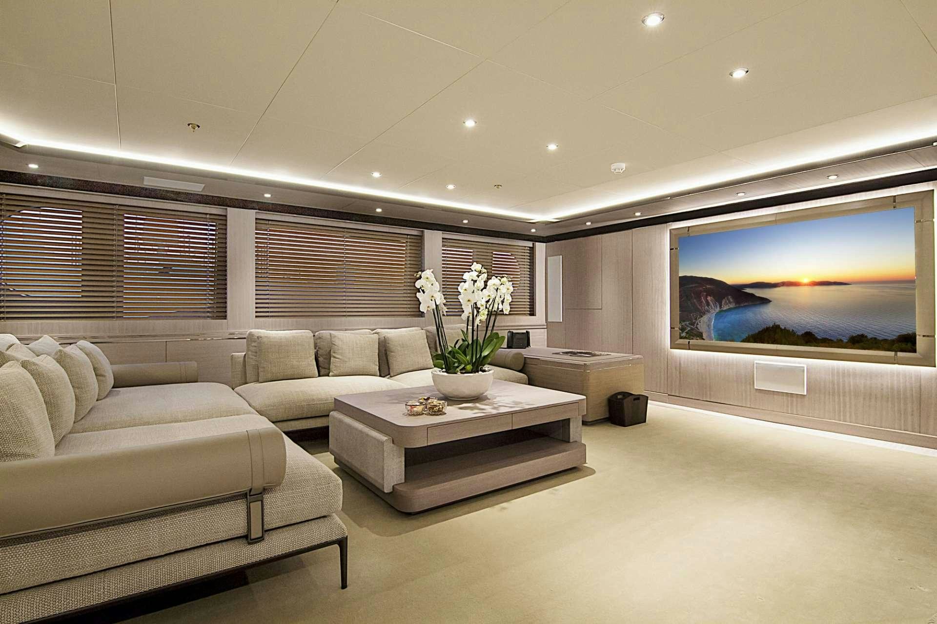 a living room with a large screen aboard INVADER Yacht for Charter