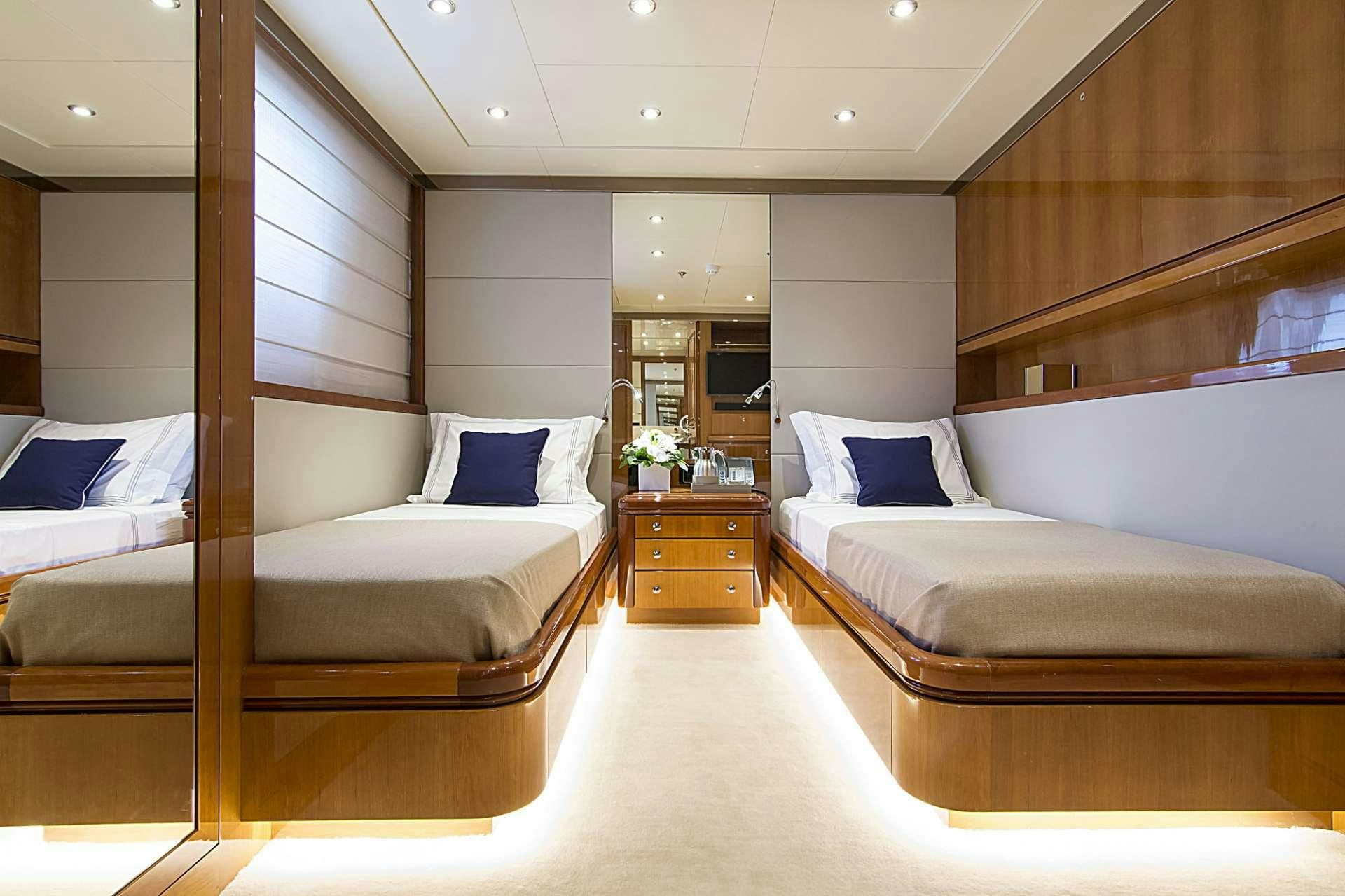 a room with a bed and a mirror aboard INVADER Yacht for Charter