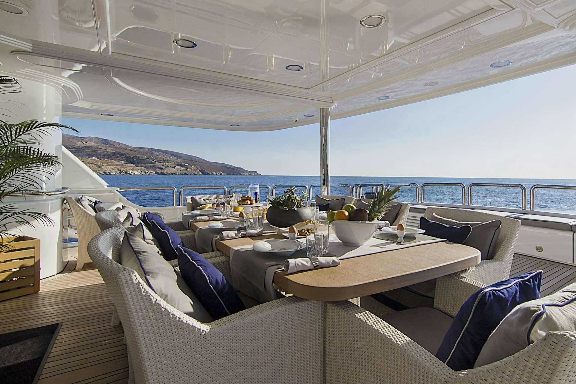 a room with a table and chairs aboard INVADER Yacht for Charter