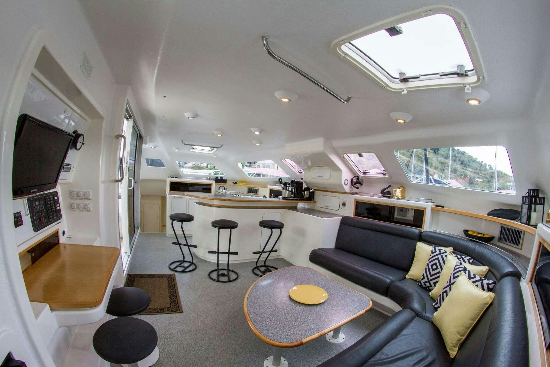 a living room with a couch and a television aboard VOYAGE 500 Yacht for Charter