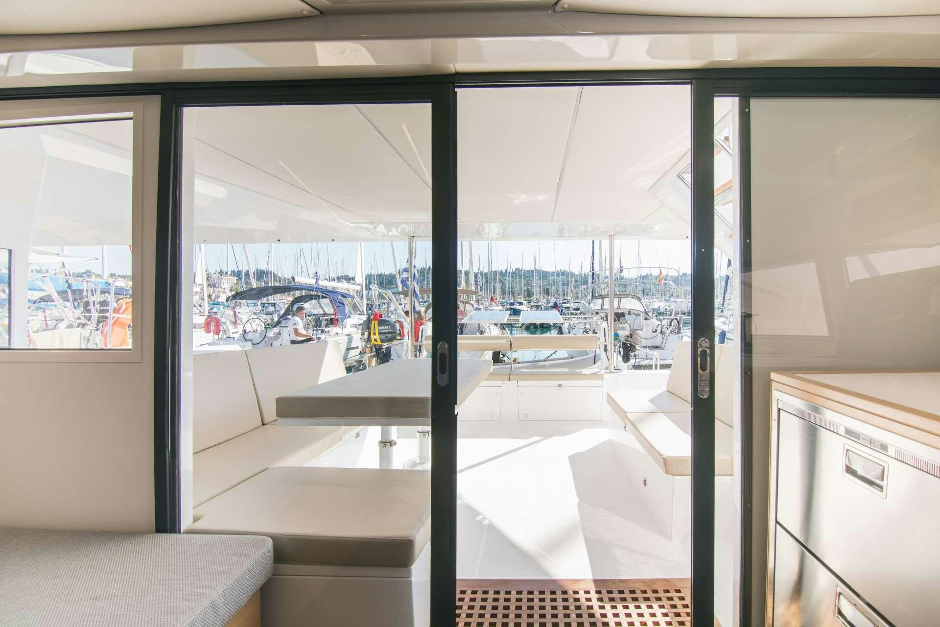 a room with a view of the water and boats aboard Sithonia Yacht for Charter