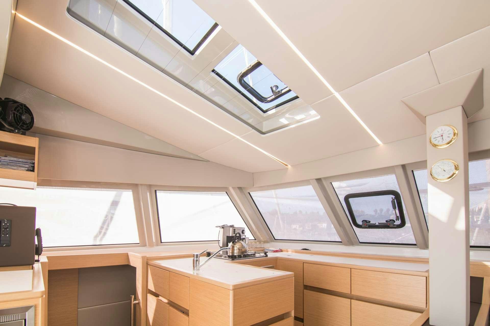 a room with a television and a clock on the wall aboard Sithonia Yacht for Charter