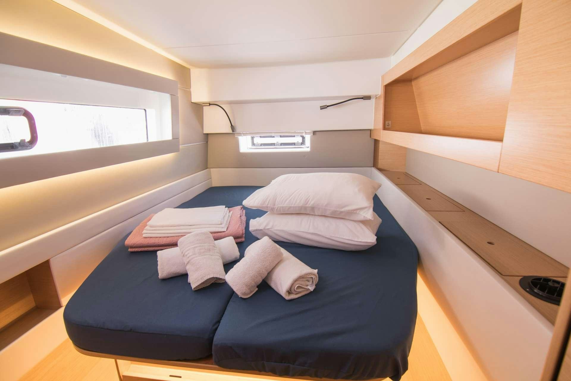 a room with a bed and a window aboard Sithonia Yacht for Charter
