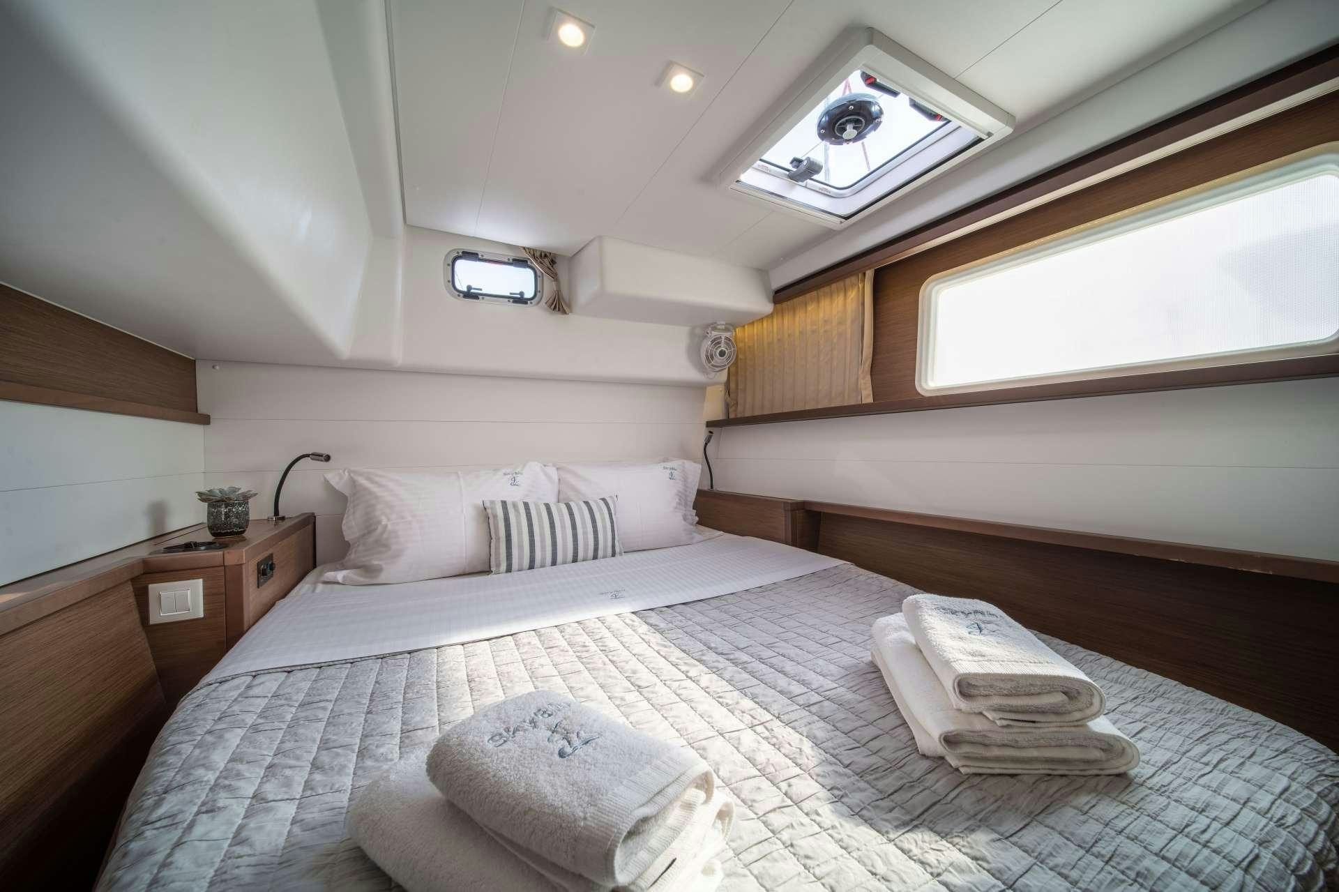 a bed with white sheets aboard SKY BLU  Yacht for Charter