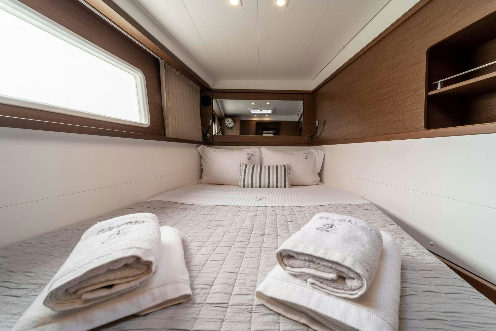 a bed with white sheets aboard SKY BLU  Yacht for Charter