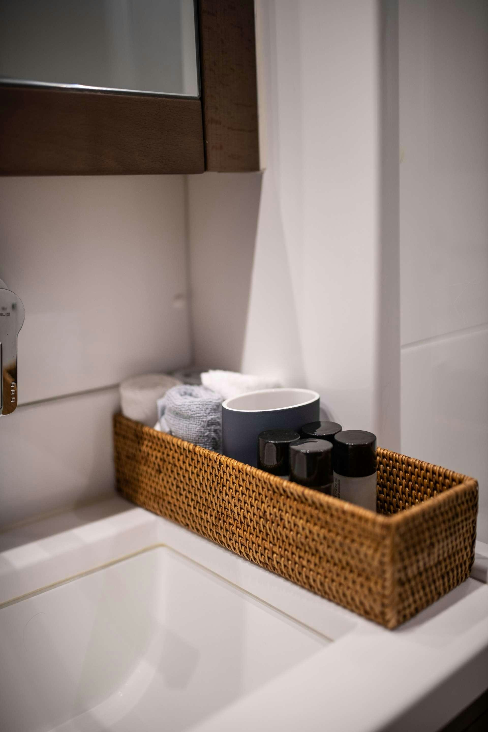 a basket of beauty products on a countertop aboard SKY BLU  Yacht for Charter
