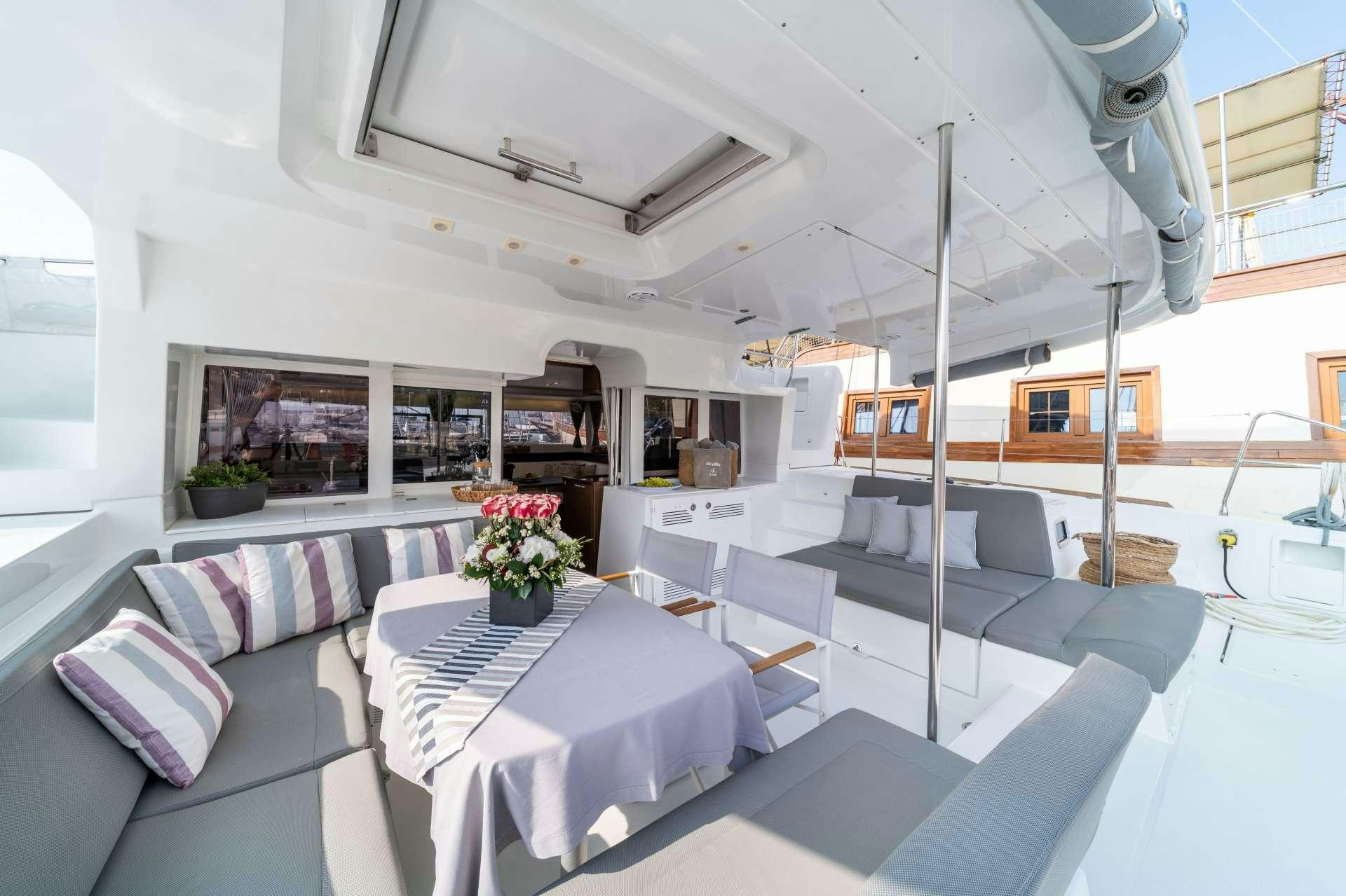 a room with a table and couches aboard SKY BLU  Yacht for Charter