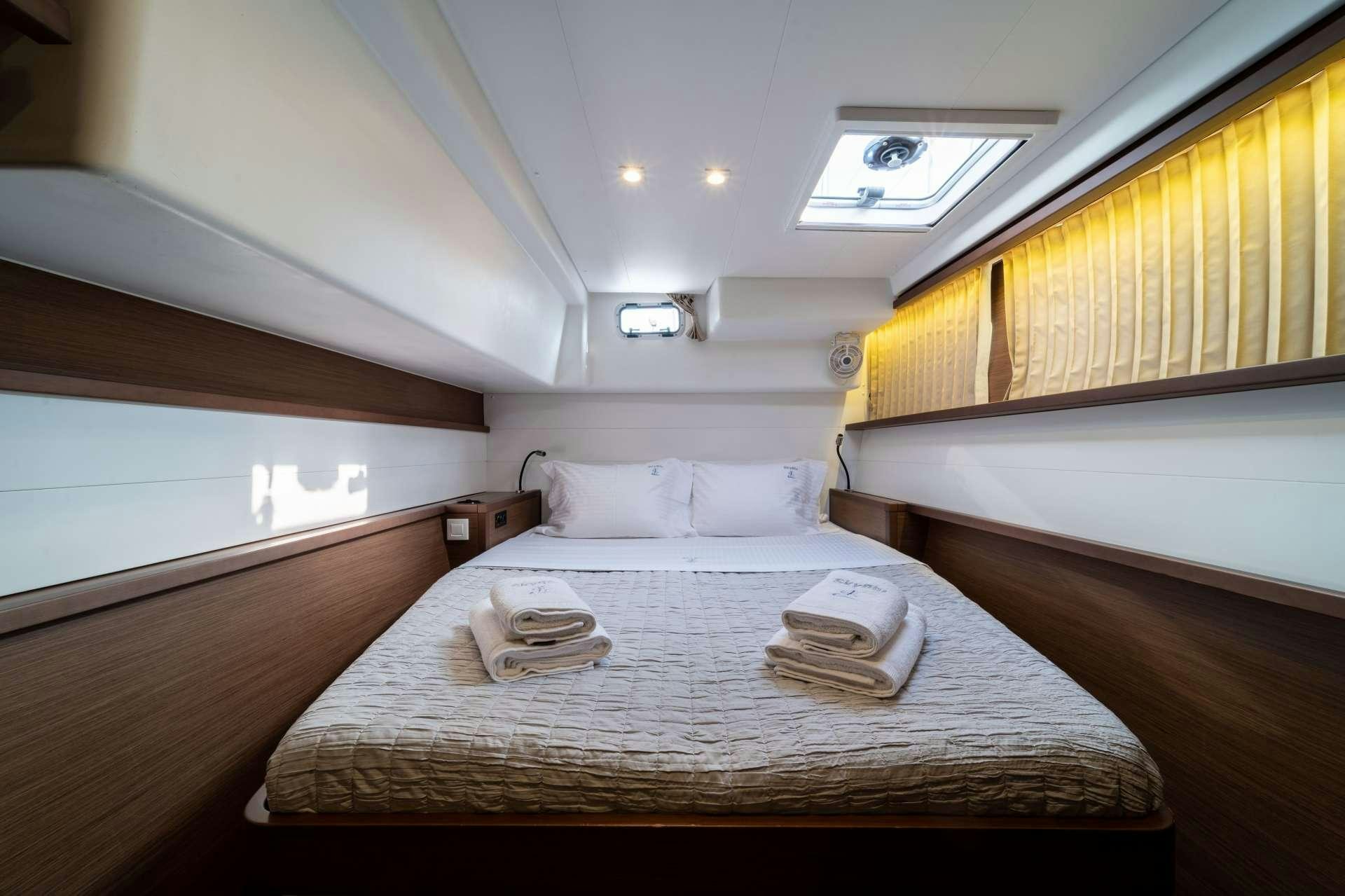a room with a bed and a table aboard SKY BLU  Yacht for Charter