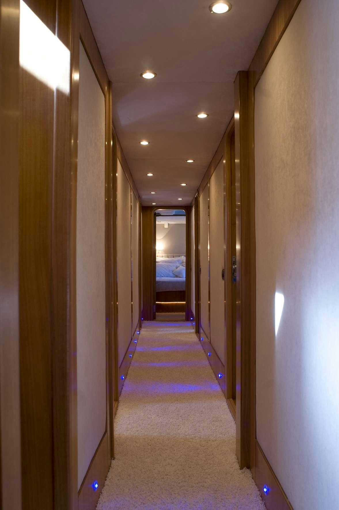 a hallway with a door and a window aboard AZMIM Yacht for Charter