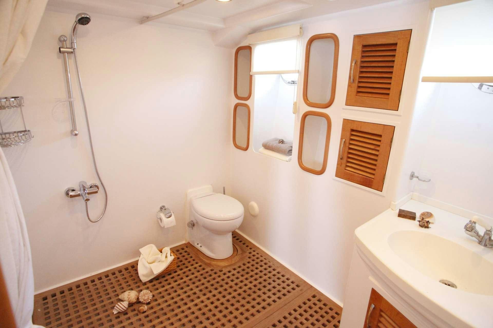a bathroom with a toilet and sink aboard AZMIM Yacht for Charter