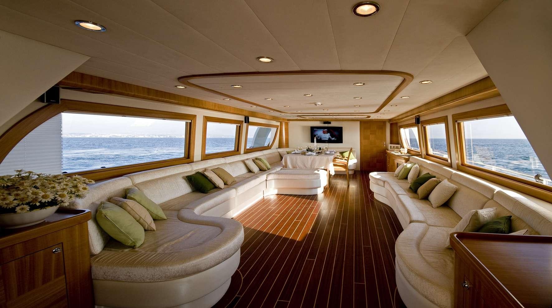 a large room with a bed and a tv aboard AZMIM Yacht for Charter