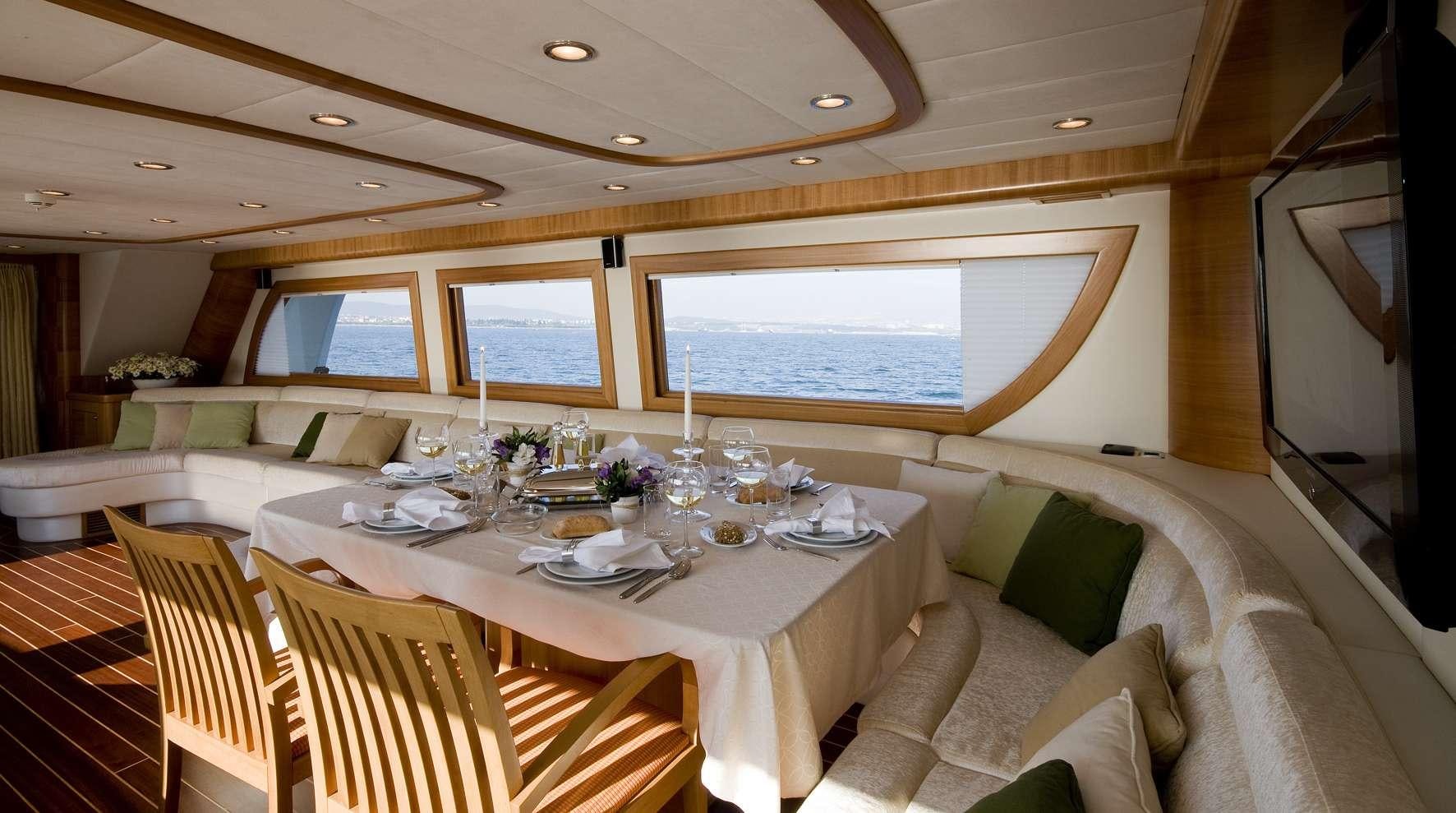 a dining table in a room aboard AZMIM Yacht for Charter