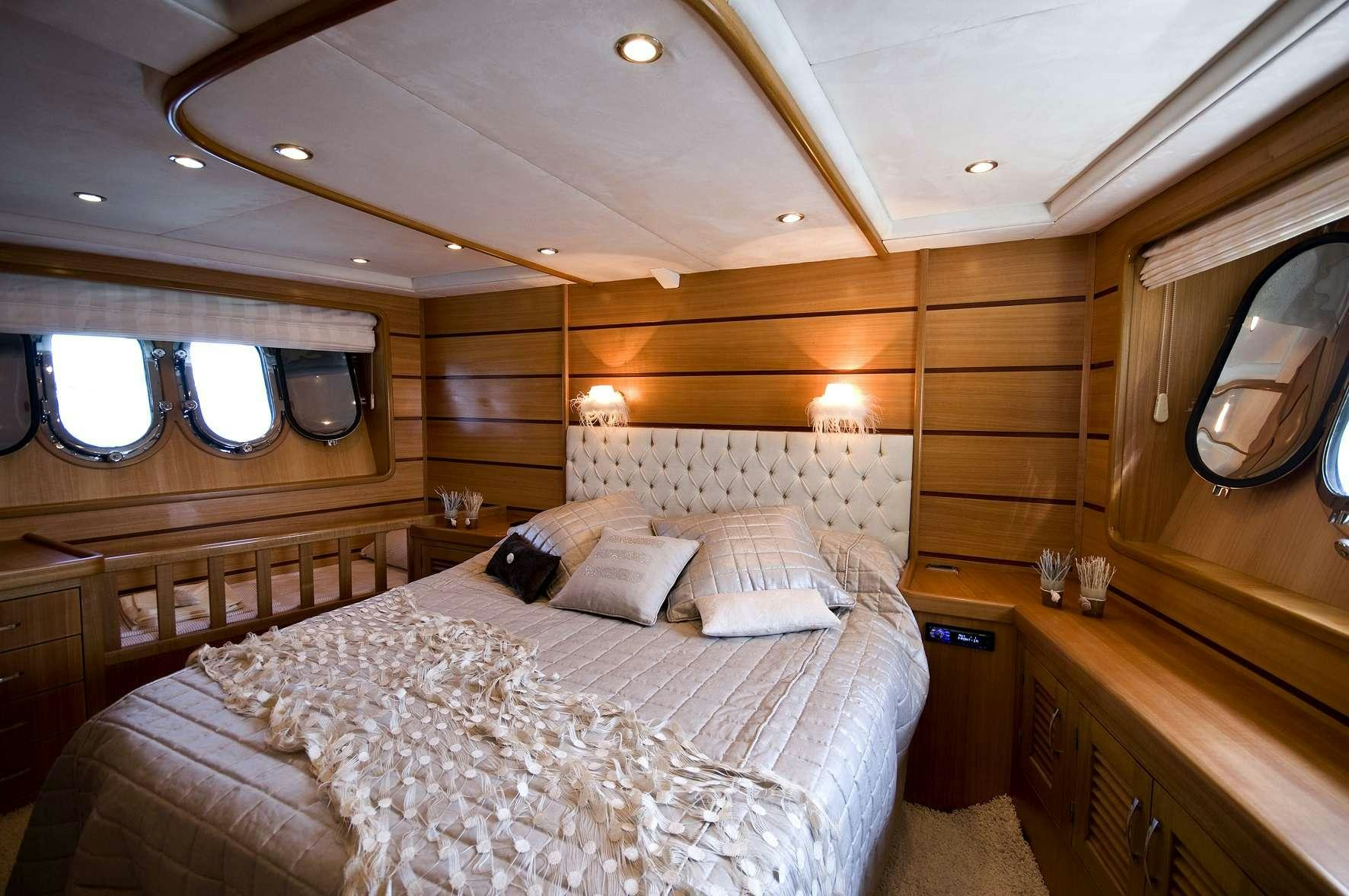 a room with a bed and a mirror aboard AZMIM Yacht for Charter
