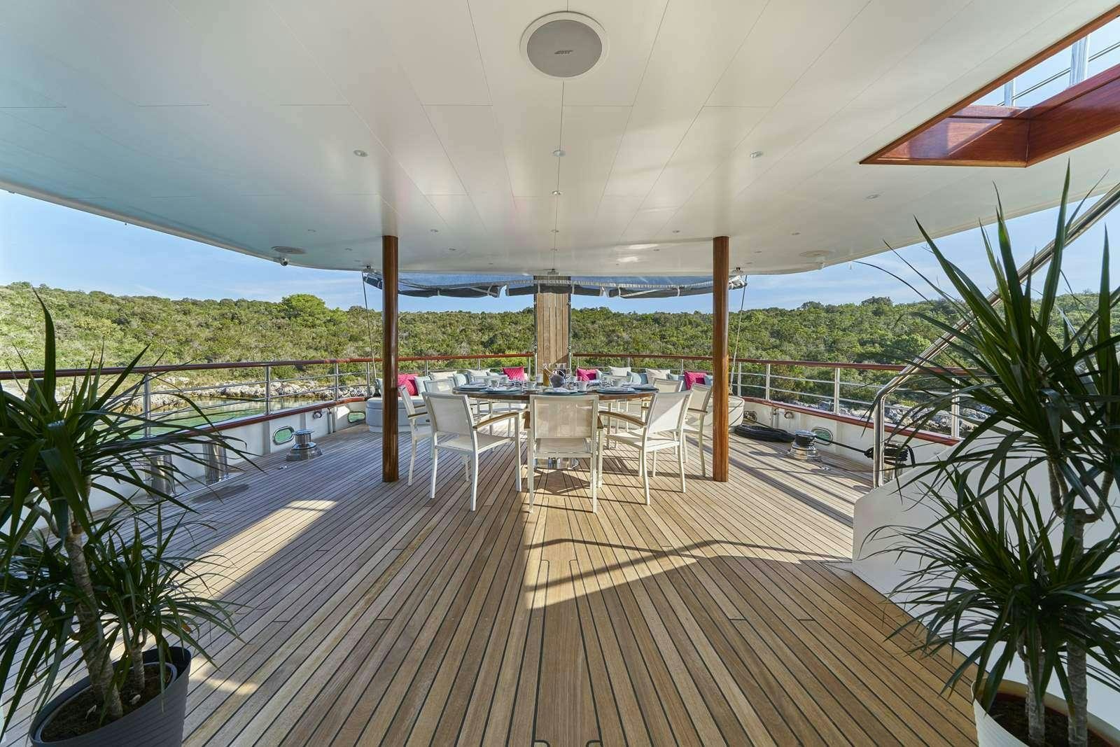 a deck with a deck and chairs aboard CORSARIO Yacht for Charter