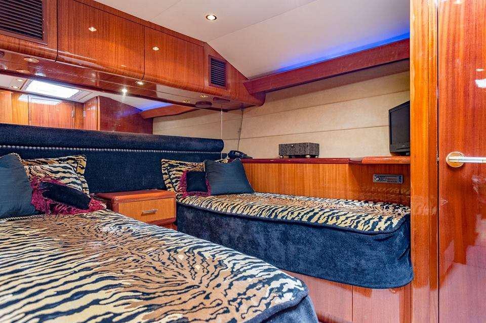 a couple of beds in a room aboard ONE NET Yacht for Charter