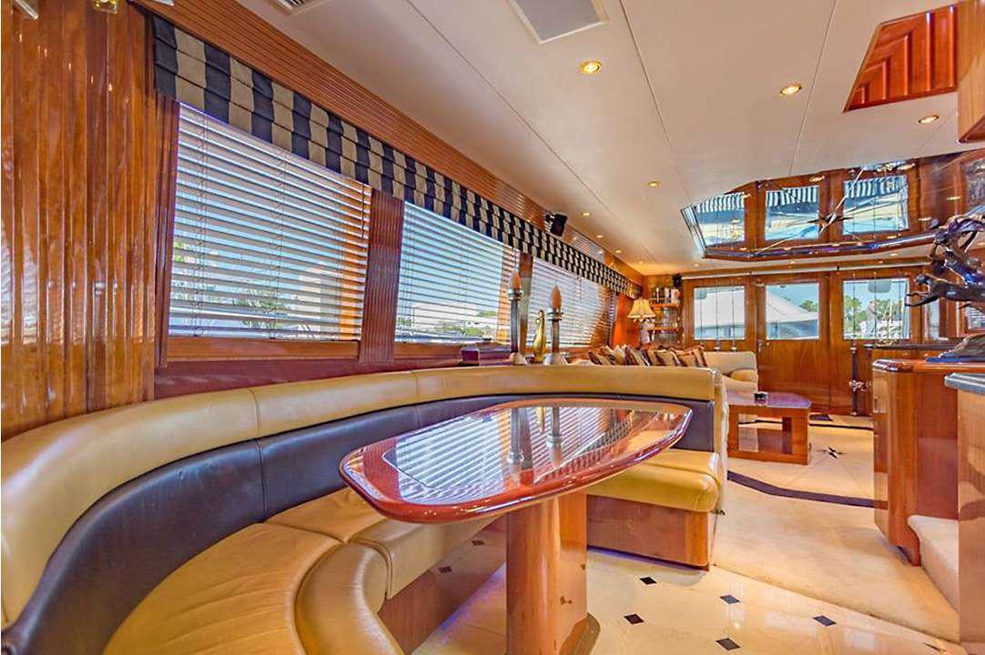 a room with a table and chairs aboard ONE NET Yacht for Charter