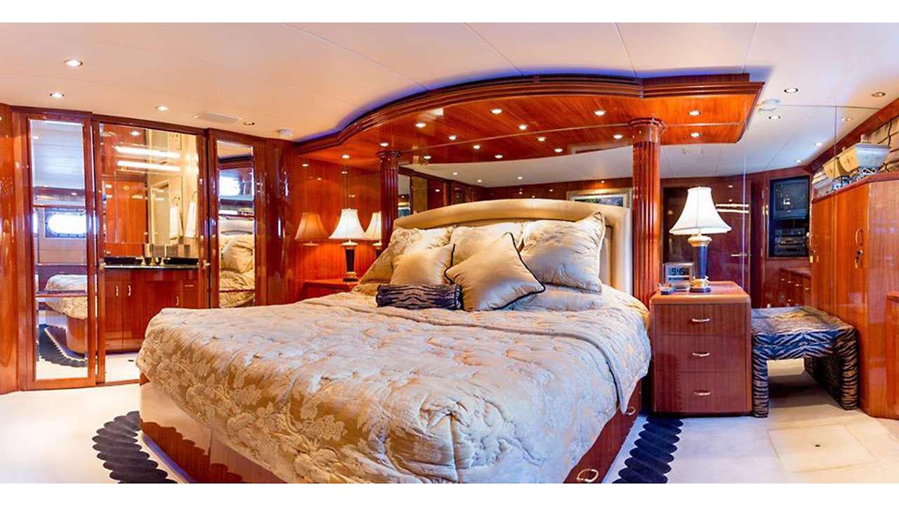 a bedroom with a large bed aboard ONE NET Yacht for Charter