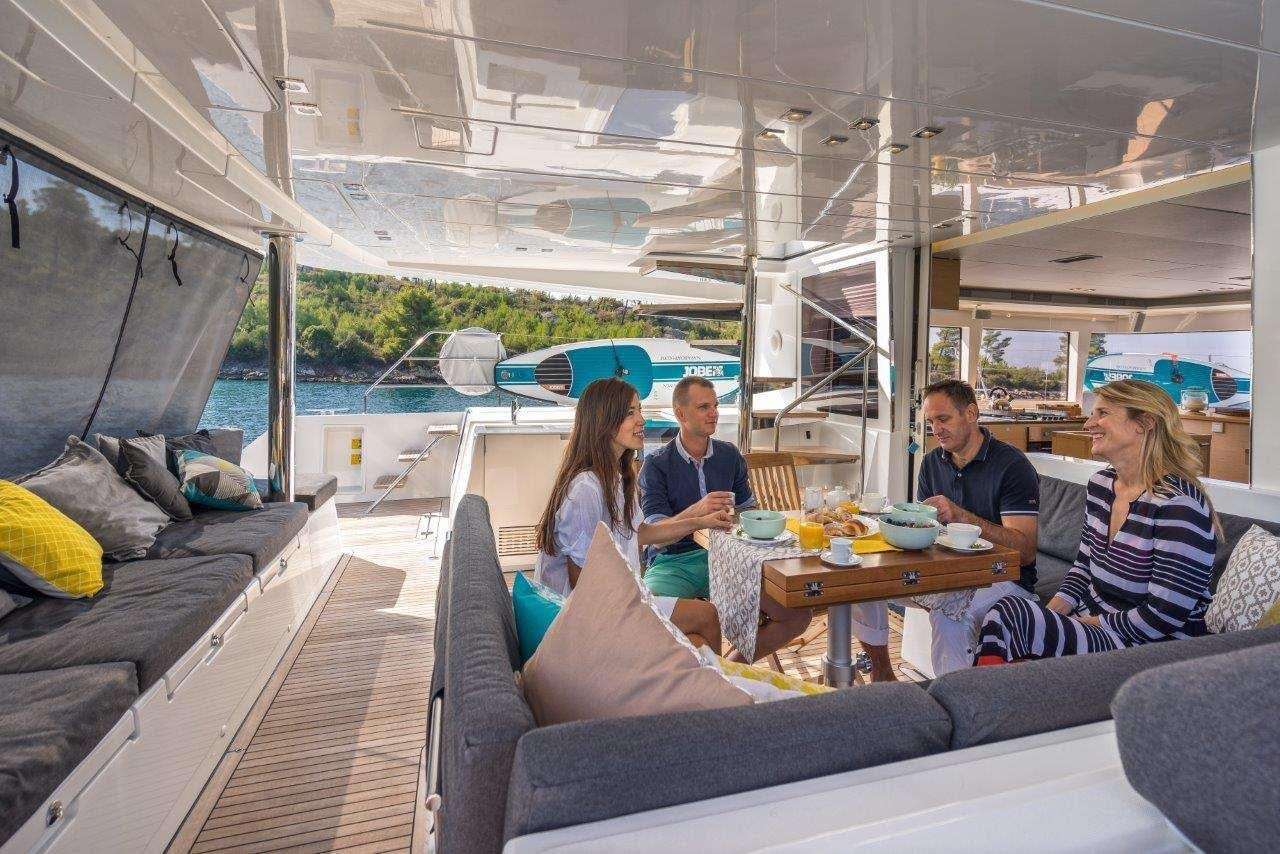 people sitting around a table aboard Pura Vida Yacht for Charter