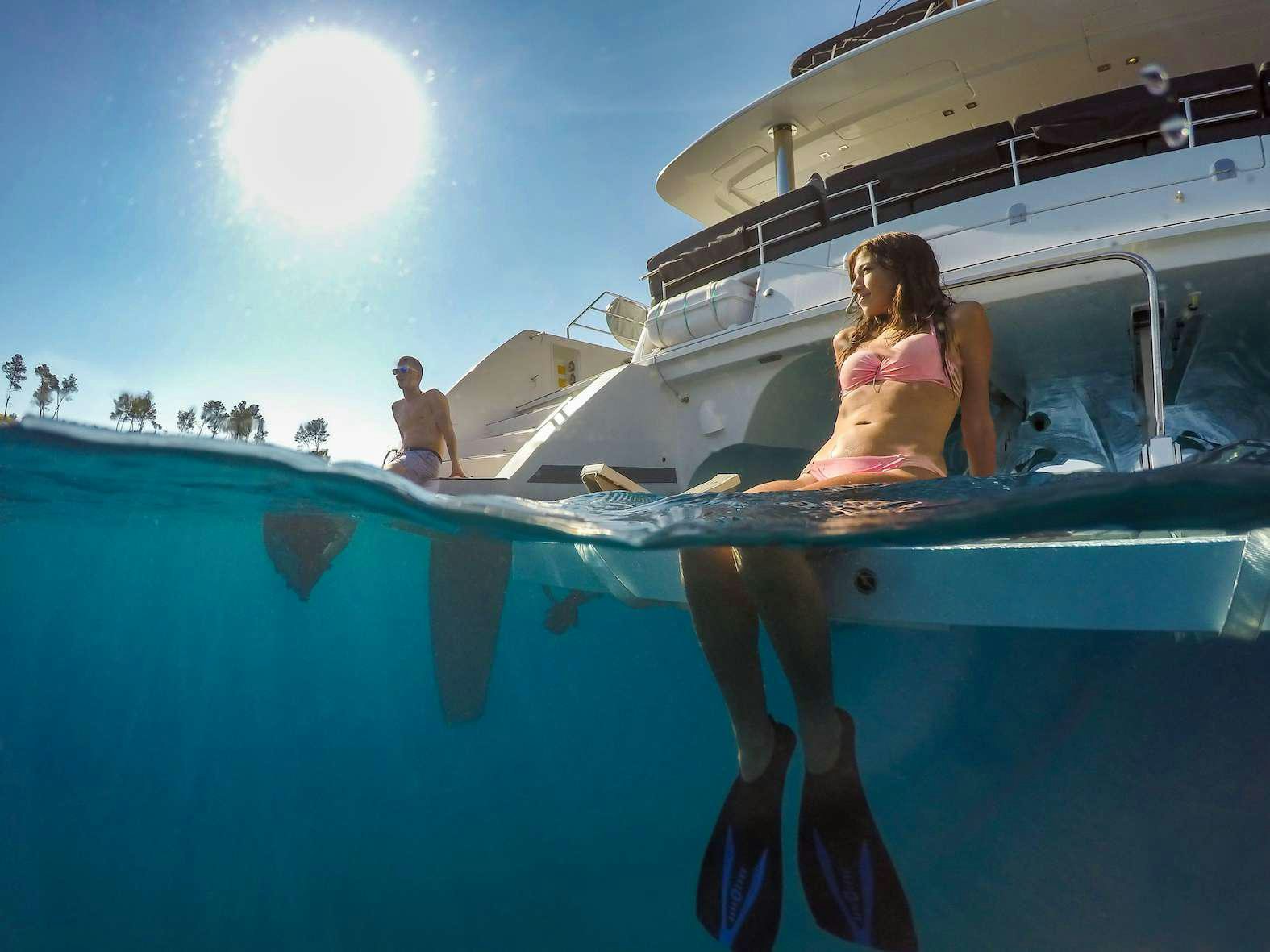 a man sitting on a boat aboard Pura Vida Yacht for Charter