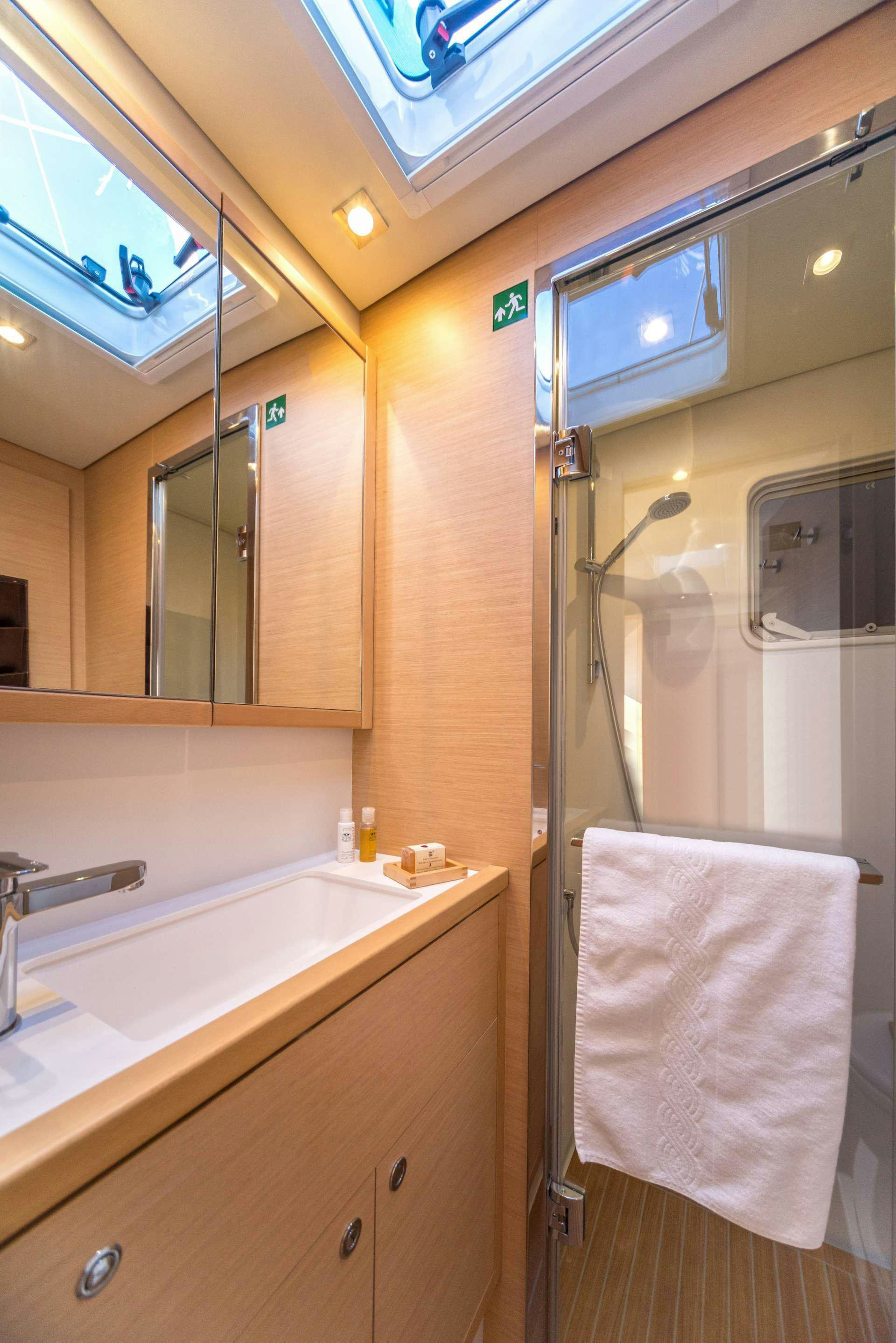a bathroom with a shower and sink aboard Pura Vida Yacht for Charter